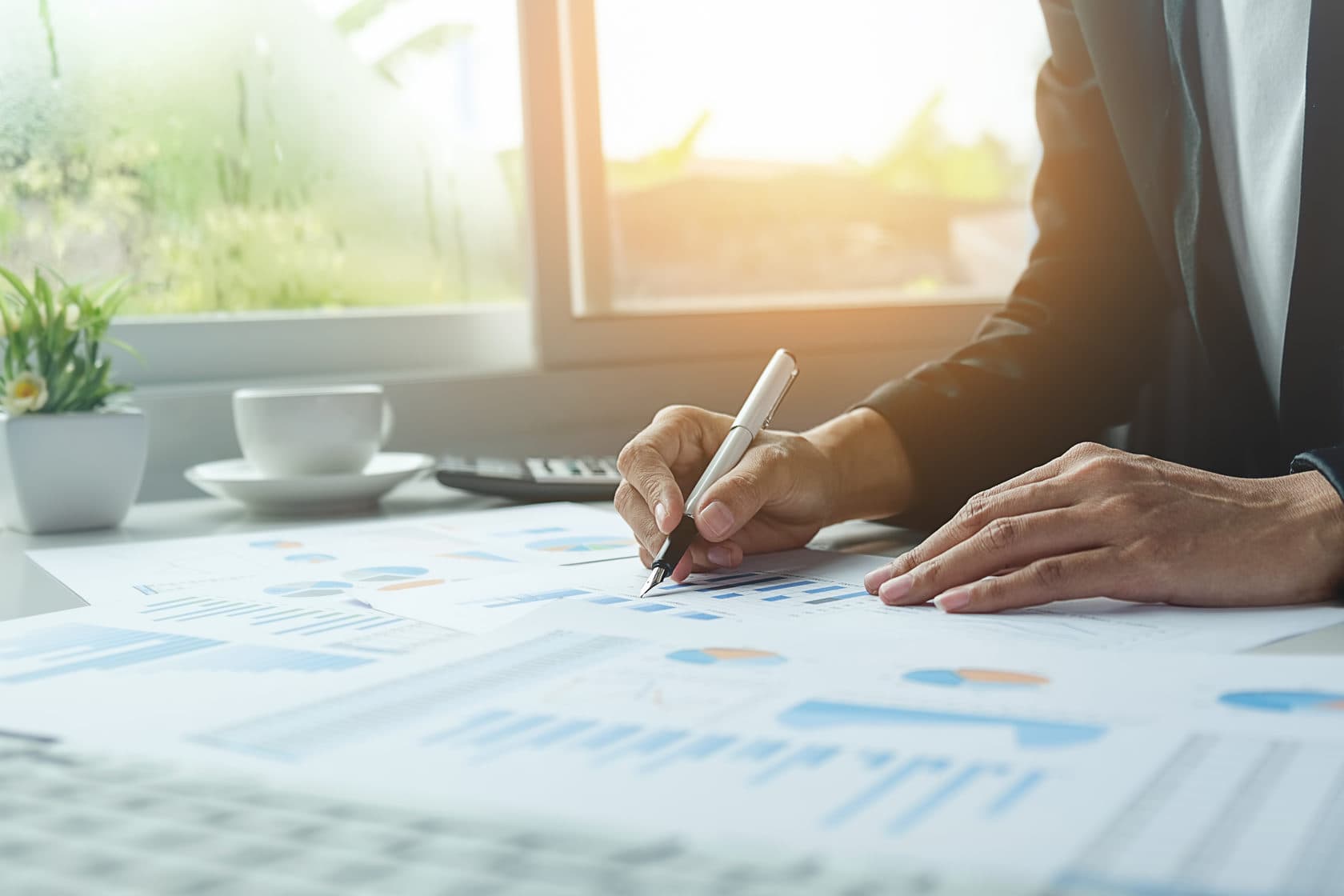 Specialist working with charts and documents at a desk